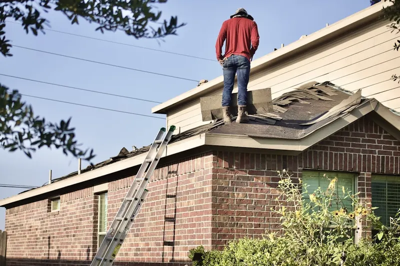 Professional roofer working on a residential roof in Walter Read Army Medical Center
